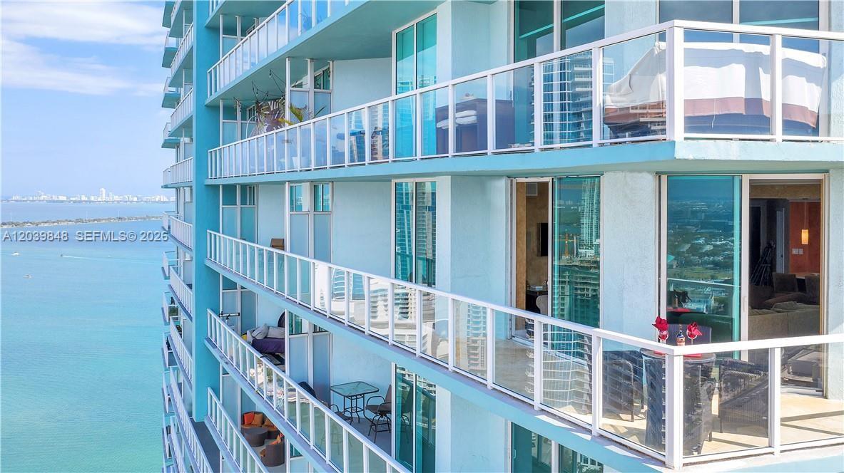 An exterior view of a high-rise building featuring multiple balconies overlooking the ocean — 1900 N Bayshore Dr # 3518, Miami FL 33132, MIAMI, FL