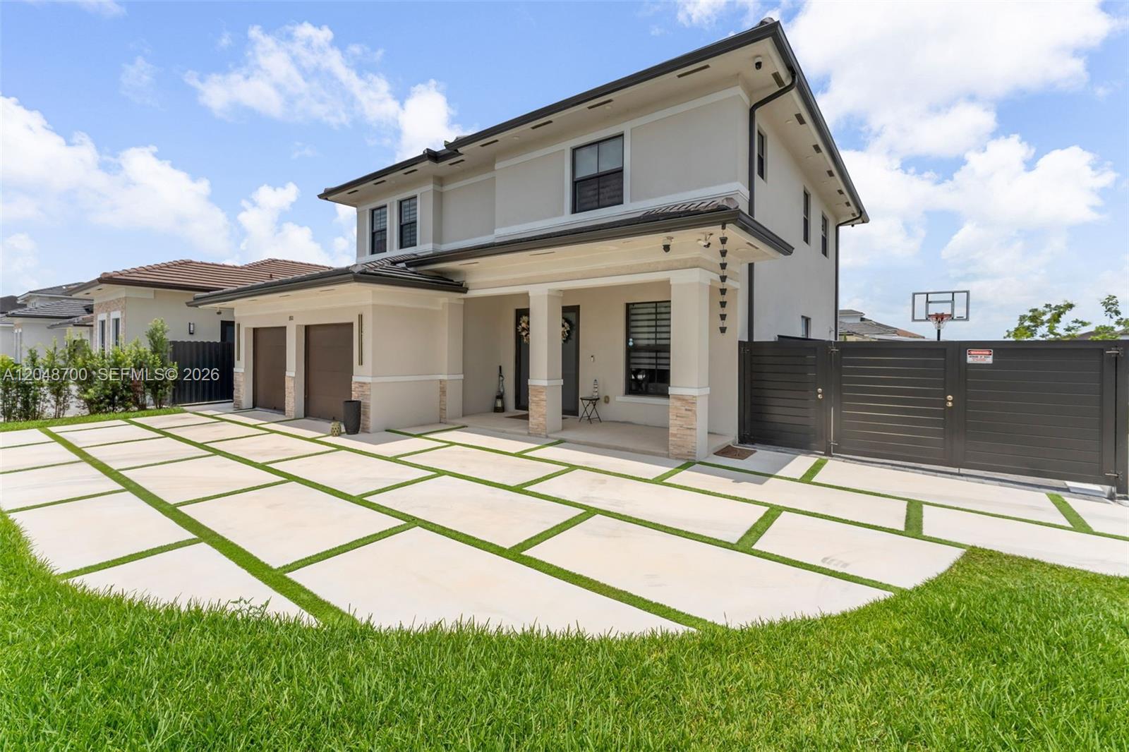A two-story house features a paved driveway with grass strips and a side gate — 1810 SW 144th Ave, Miami FL 33175, MIAMI, FL