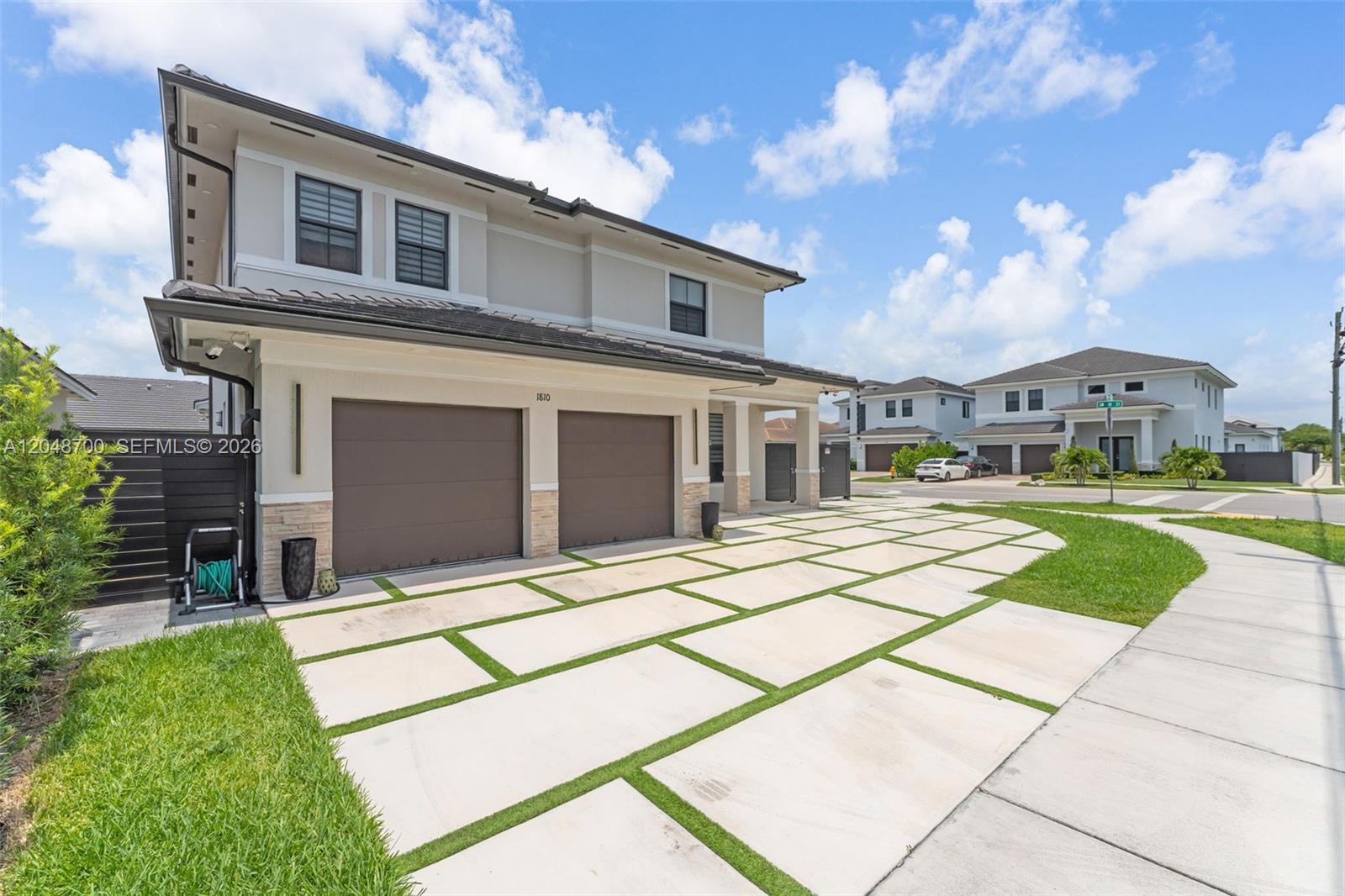 A two-story house features a two-car garage and a concrete paver driveway with grass joints — 1810 SW 144th Ave, Miami FL 33175, MIAMI, FL