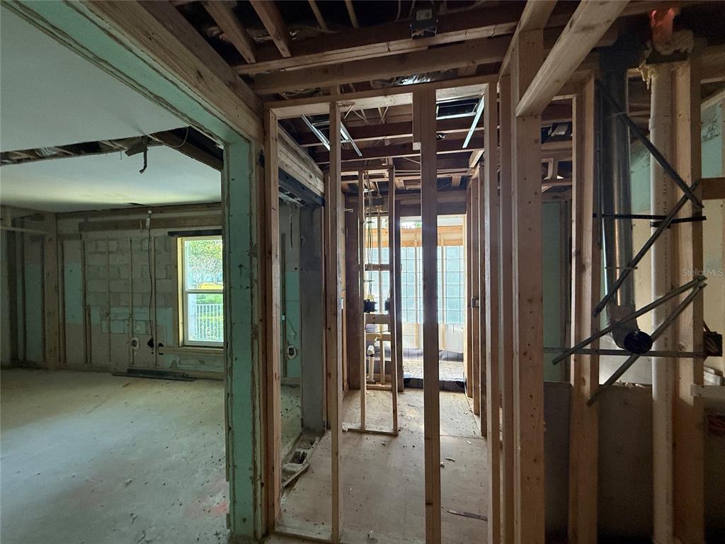 An interior view of a home under construction with exposed wooden wall studs and framing — 1015 S PALM AVENUE, ORLANDO, FL