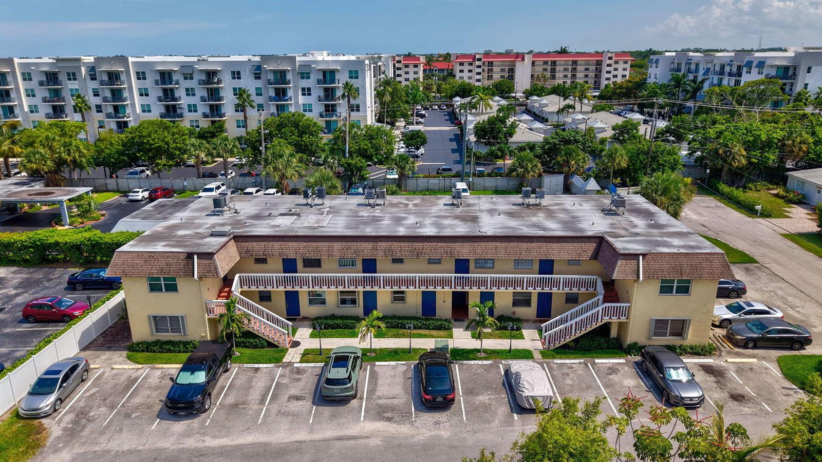 An aerial view of a two-story apartment building with a parking lot in front — 1204 S Lake Drive E # 3, Lantana FL 33462, LANTANA, FL