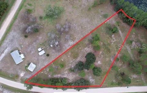 An aerial view shows a plot of land outlined in red with several small structures — 116 OSCEOLA ROAD, GEORGETOWN, FL