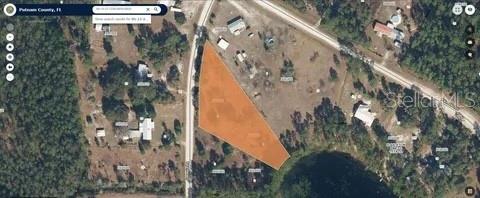 This is an aerial map view showing a vacant, irregularly shaped lot highlighted in orange — 116 OSCEOLA ROAD, GEORGETOWN, FL