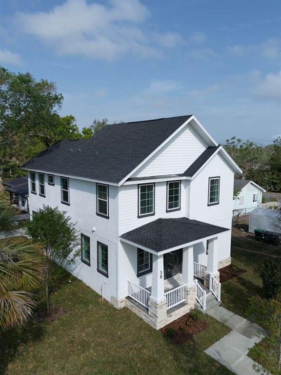 An aerial view of a two-story white house with a dark roof and front porch — 38 S POLLARD STREET, OAKLAND, FL
