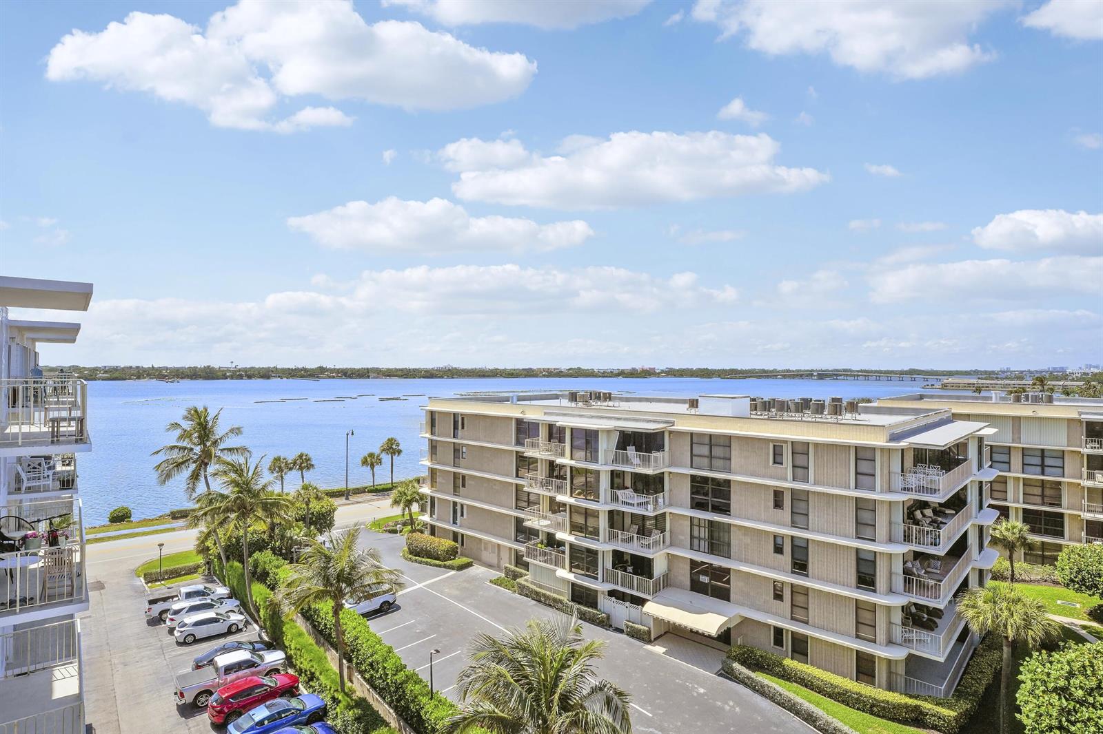 An elevated view of a multi-story apartment building with a parking lot and waterfront — 3230 S Ocean Boulevard # 607, Palm Beach FL 33480, PALM BEACH, FL