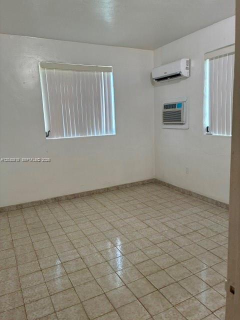 An empty room features tiled floors, white walls, two windows with blinds, and an air conditioner — 6741 SW 5th Ter, Miami FL 33144, MIAMI, FL