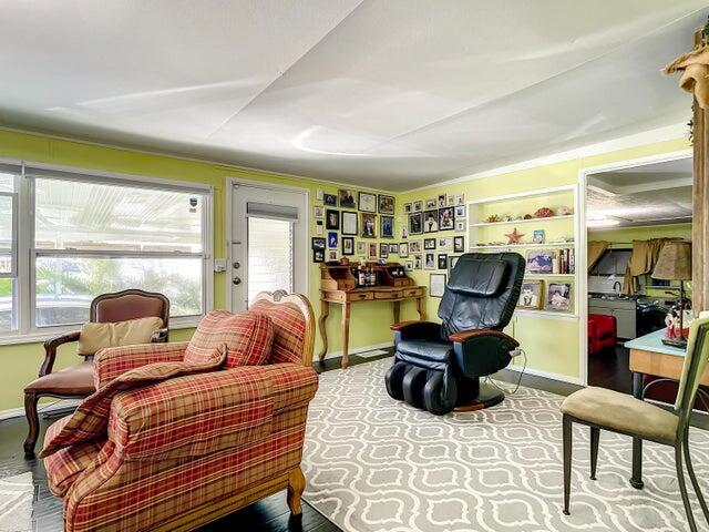 A living room features a plaid armchair, a black massage chair, and a wooden desk — 4215 Meadow View Drive, Boynton Beach FL 33436, BOYNTON BEACH, FL