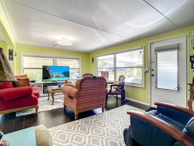 A living room with lime green walls, a patterned rug, and several pieces of furniture — 4215 Meadow View Drive, Boynton Beach FL 33436, BOYNTON BEACH, FL