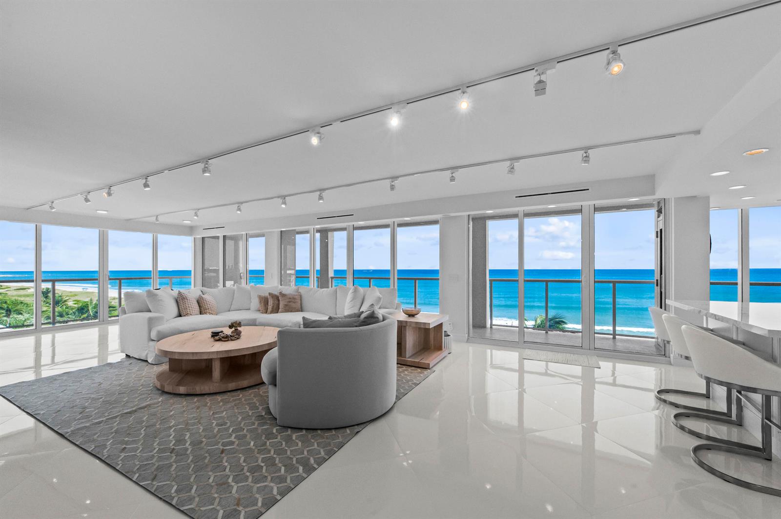 A bright living room features white tile floors, a sectional sofa, and floor-to-ceiling ocean views — 2800 S Ocean Boulevard # A, Boca Raton FL 33432, BOCA RATON, FL