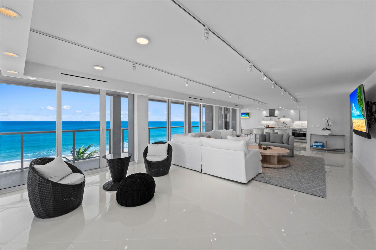 A bright, open-concept living room features white tile floors, a sectional sofa, and ocean views — 2800 S Ocean Boulevard # A, Boca Raton FL 33432, BOCA RATON, FL