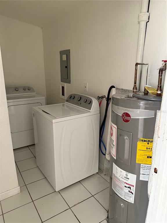 A laundry room contains a top-loading washing machine, a dryer, and a water heater — 4737 56TH AVENUE N, ST PETERSBURG, FL