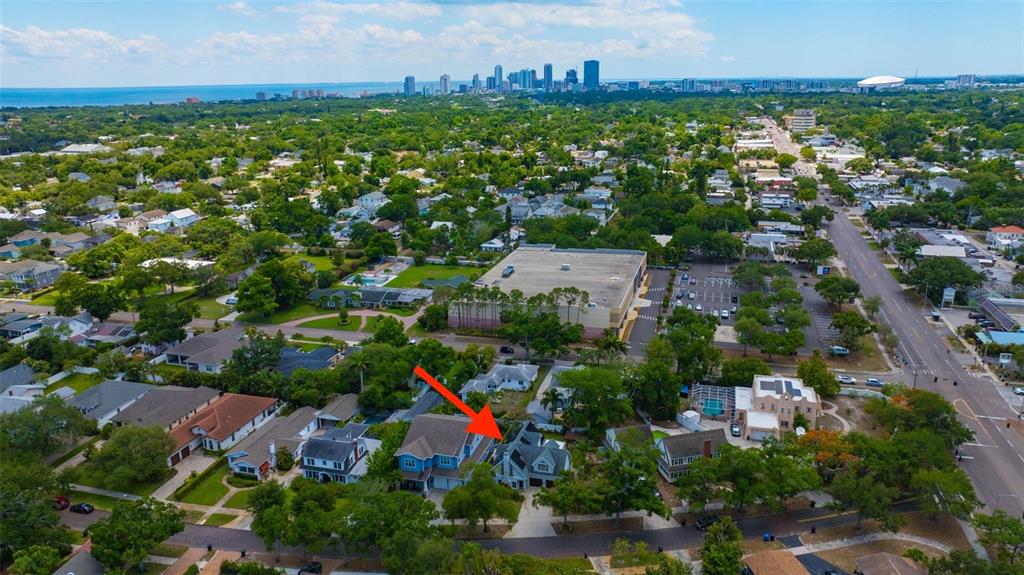 An aerial view shows a residential neighborhood with a red arrow pointing to a house — 852 35TH AVENUE N, ST PETERSBURG, FL