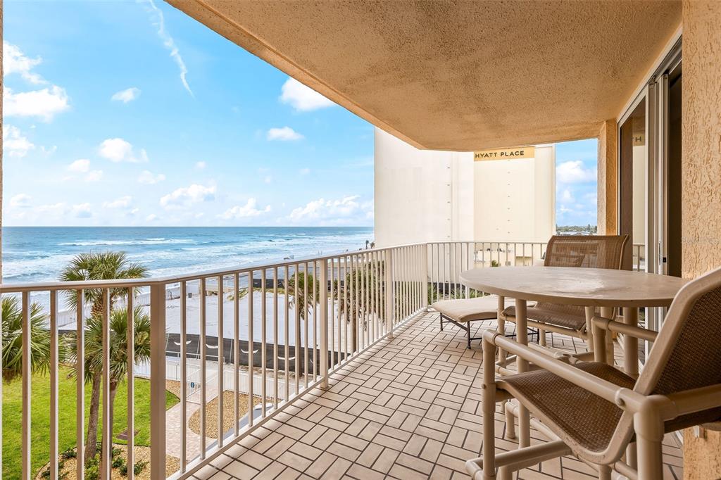 A balcony with tile flooring, patio furniture, and a view of the ocean and beach — 3145 S ATLANTIC AVENUE UNIT 405, DAYTONA BEACH SHORES, FL