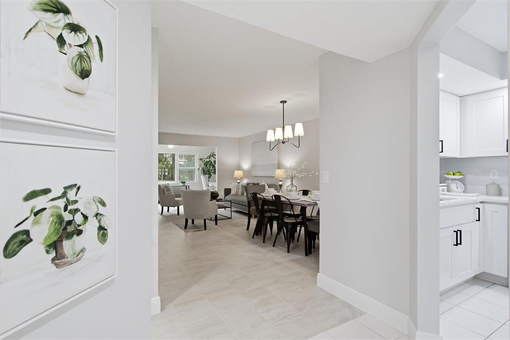 A view from a hallway looking into a dining area and living room with tile floors — 1241 S MARTIN LUTHER KING JR AVENUE UNIT 104, CLEARWATER, FL