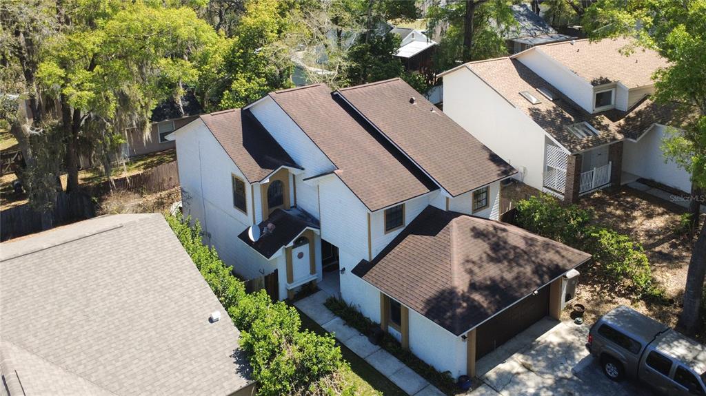 An aerial view of a two-story white house with a brown shingled roof and garage — 1777 SUMMIT CHASE AVENUE, APOPKA, FL
