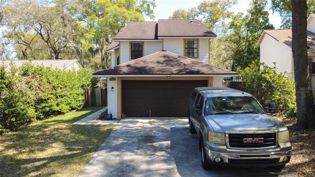 A two-story house with a brown roof, white siding, and a single-car garage — 1777 SUMMIT CHASE AVENUE, APOPKA, FL