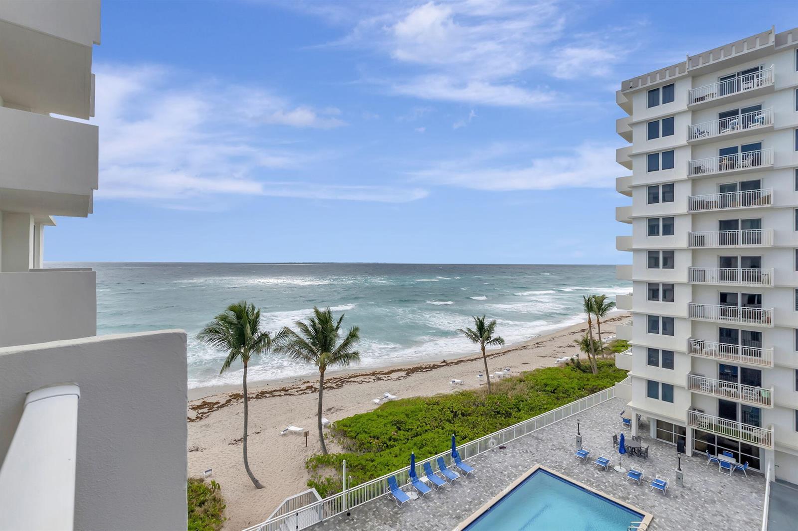 A high-angle view of a beach, ocean, swimming pool, and a multi-story residential building — 3215 S Ocean Boulevard # 509, Highland Beach FL 33487, HIGHLAND BEACH, FL