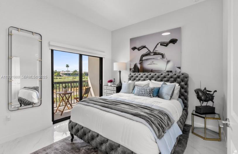 A bedroom features a tufted bed, a wall-mounted mirror, and a sliding door to a balcony — 2320 E 4th Ave # 102, Hialeah FL 33013, HIALEAH, FL
