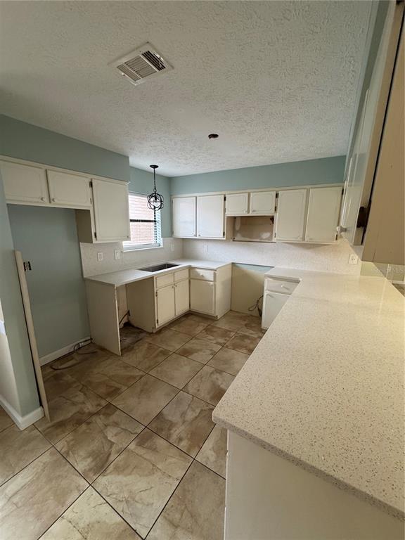 A bathroom features a wooden vanity with a granite countertop, a round mirror, and a towel bar — 143 GRANDE ISLAND BLVD BOULEVARD, PANAMA CITY BEACH, FL