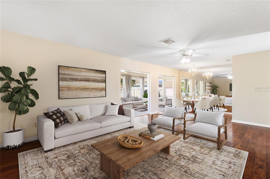 A living room features a beige sofa, two armchairs, a wooden coffee table, and hardwood floors — 679 FORT DUQUESNA DRIVE, SUN CITY CENTER, FL