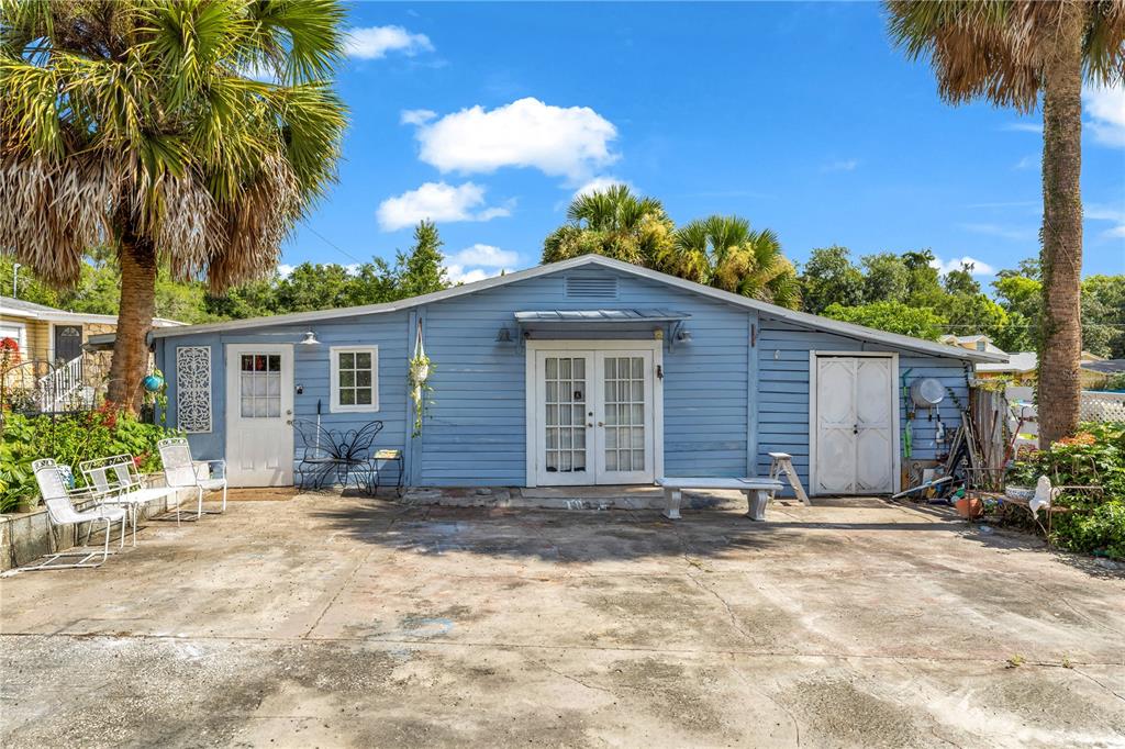 An aerial view shows several houses on a large, grassy lot with many trees — 405 W SIMON AVENUE, APOPKA, FL