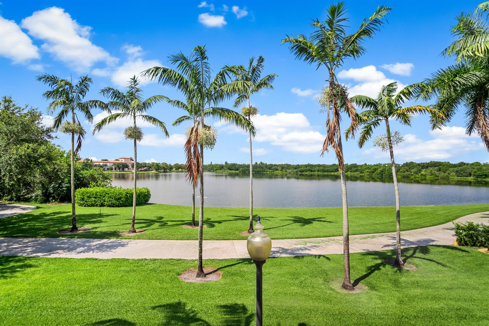 A view of a lake surrounded by palm trees and a grassy lawn — 1430 NW 48th Lane, Boca Raton FL 33431, BOCA RATON, FL