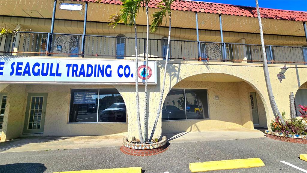 The exterior of a commercial building features a red tile roof and palm trees — 530 US-41-BYP UNIT 17 and 18A, VENICE, FL