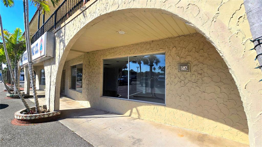 The exterior of a commercial building features a stucco facade, arched walkway, and large windows — 530 US-41-BYP UNIT 17 and 18A, VENICE, FL