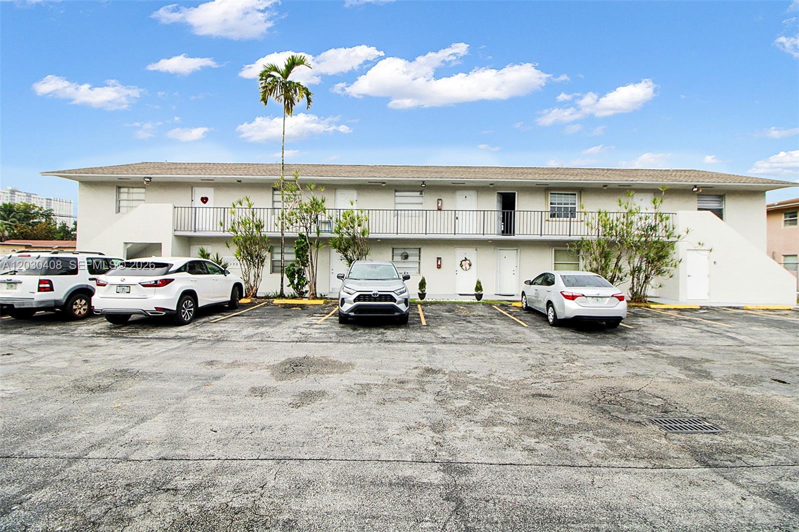 A two-story apartment building with a parking lot and several cars in front — 10745 SW 3rd St # 6, Sweetwater FL 33174, SWEETWATER, FL