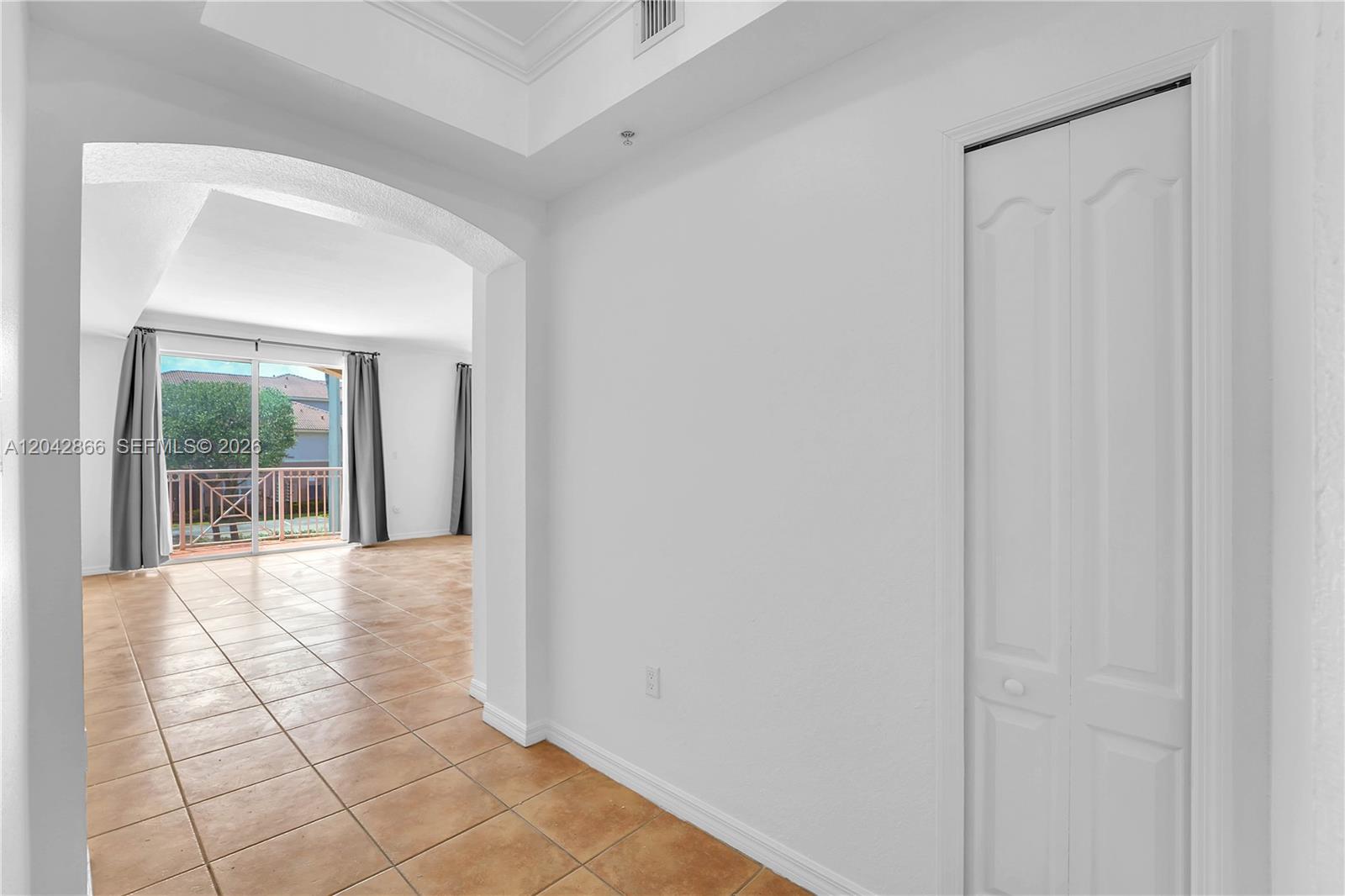 An exterior view shows a peach-colored building with a staircase leading to upper levels — 8858 W Flagler St # 210, Miami FL 33174, MIAMI, FL