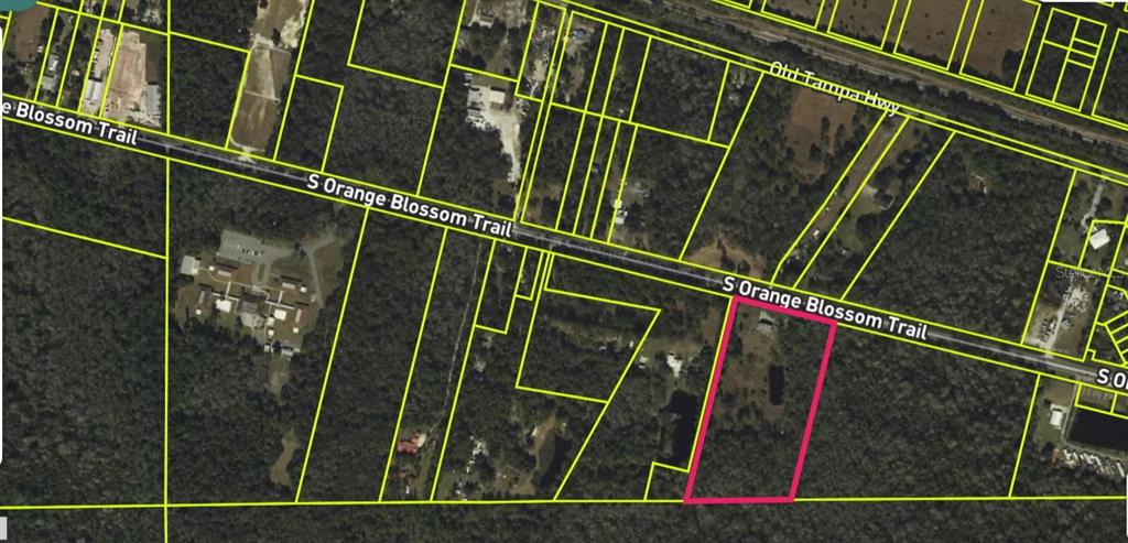 An aerial map view shows a rectangular parcel of land highlighted in pink — 5800 S ORANGE BLOSSOM TRAIL, DAVENPORT, FL