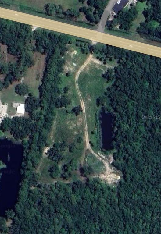 This aerial map shows a wooded lot with a dirt driveway and a small pond — 5800 S ORANGE BLOSSOM TRAIL, DAVENPORT, FL