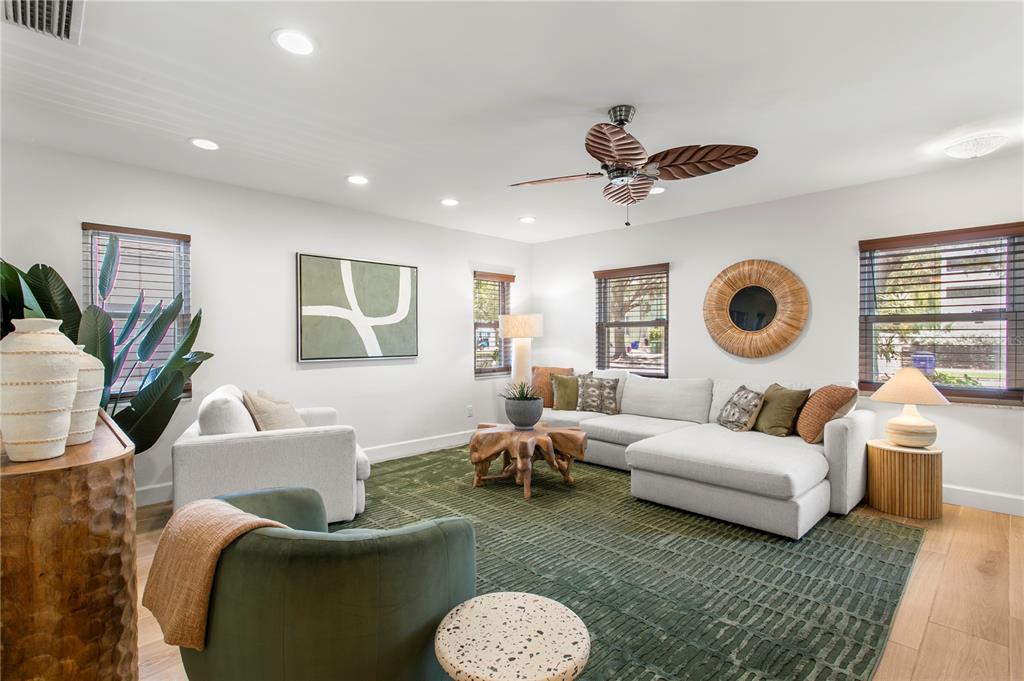 A living room features a green area rug, a sectional sofa, and a ceiling fan — 508 COLUMBIA DRIVE, TAMPA, FL