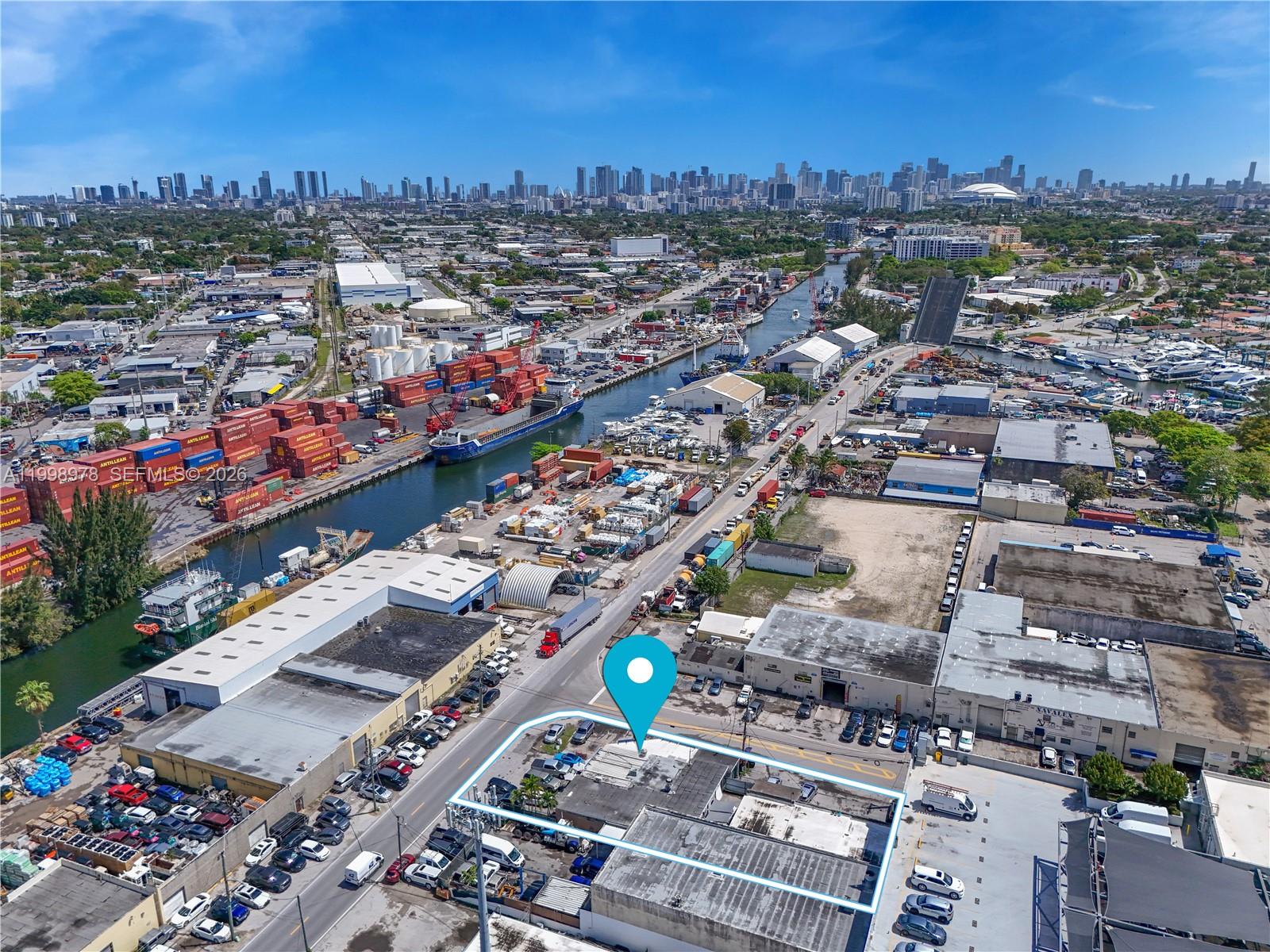An aerial view shows a commercial building with a parking lot in an industrial area — 3300 NW South River Dr, Miami FL 33142, MIAMI, FL