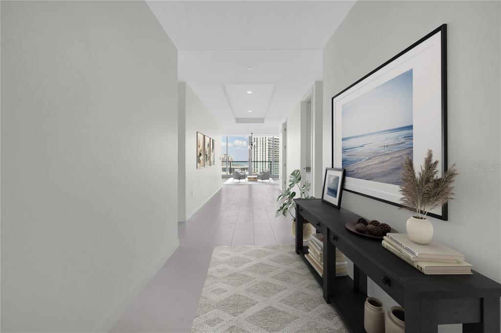 A hallway with light flooring leads to a bright living area with floor-to-ceiling windows — 400 CENTRAL AVENUE UNIT 2207, ST PETERSBURG, FL