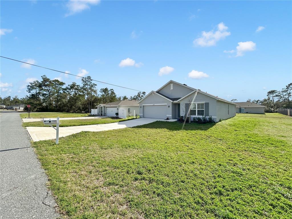 A single-story house with a gray exterior, a two-car garage, and a concrete driveway — 16820 SW 29TH TERRACE ROAD, OCALA, FL