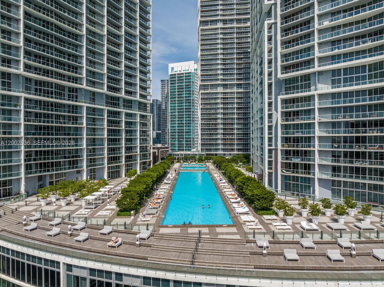 An aerial view of a long swimming pool situated between two tall residential towers — 485 Brickell Ave # 4104, Miami FL 33131, MIAMI, FL