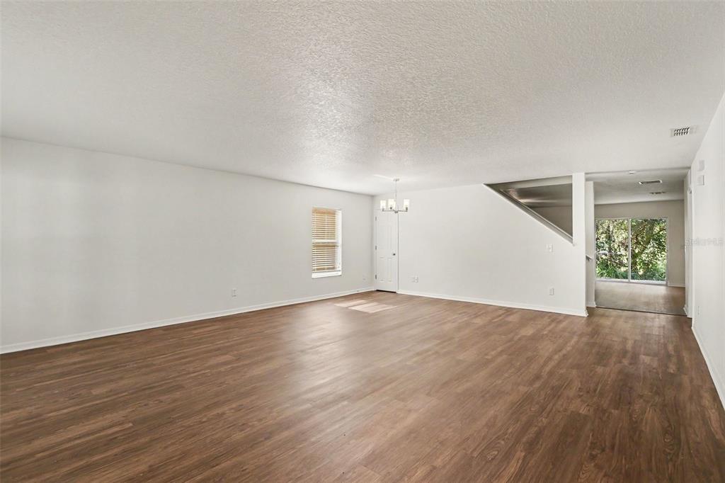 A two-story house with a white garage door, brown siding, and a concrete driveway — 1544 ALGONKIN LOOP, ORLANDO, FL