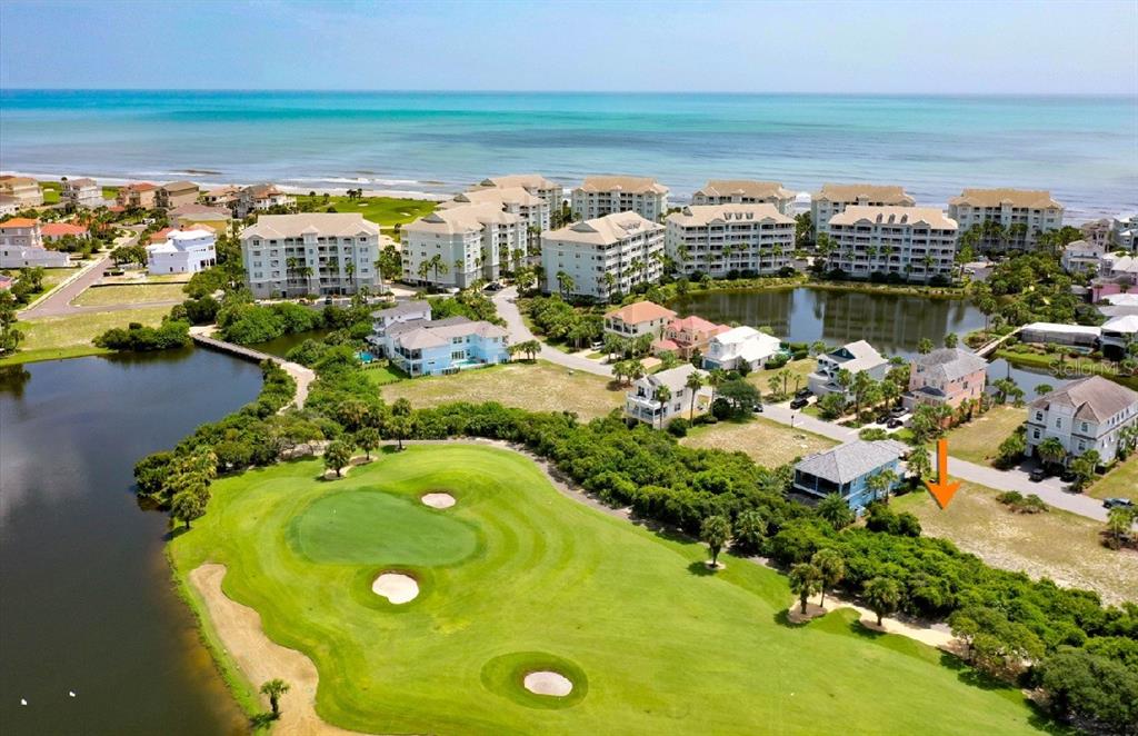 An aerial view shows a vacant residential lot next to a golf course and ocean — 39 CINNAMON BEACH WAY, PALM COAST, FL