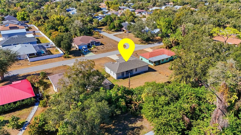 An aerial view shows a single-story house with a gray roof and a yellow pin — 1466 DEWITT STREET, PORT CHARLOTTE, FL