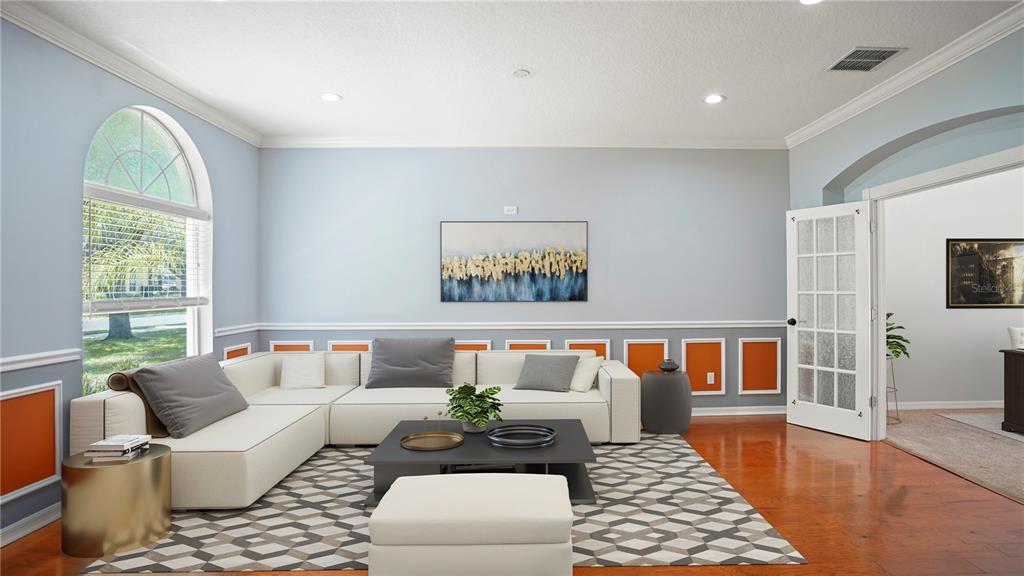 A living room features a white sectional sofa, a geometric rug, and orange wall panels — 1355 EDISON TREE ROAD, APOPKA, FL