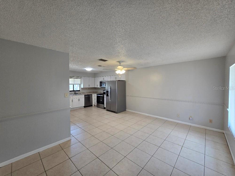 A kitchen and dining area with stainless steel appliances, white cabinets, and tiled flooring — 780 E NORTH STREET, BARTOW, FL