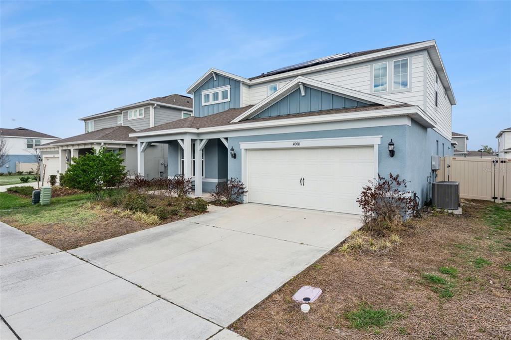 A two-story blue house with a white garage and a concrete driveway — 4008 MEANDERING BAY DRIVE, APOPKA, FL