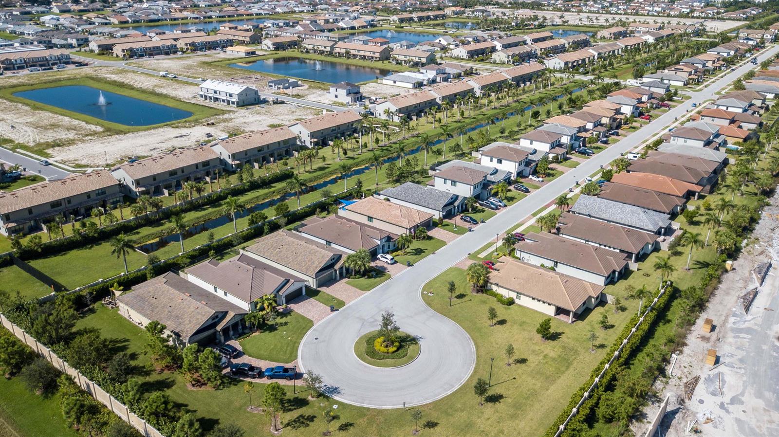 An aerial view shows a suburban neighborhood with houses, a cul-de-sac, and retention ponds — 8161 Hanoverian Drive, Lake Worth FL 33467, LAKE WORTH, FL