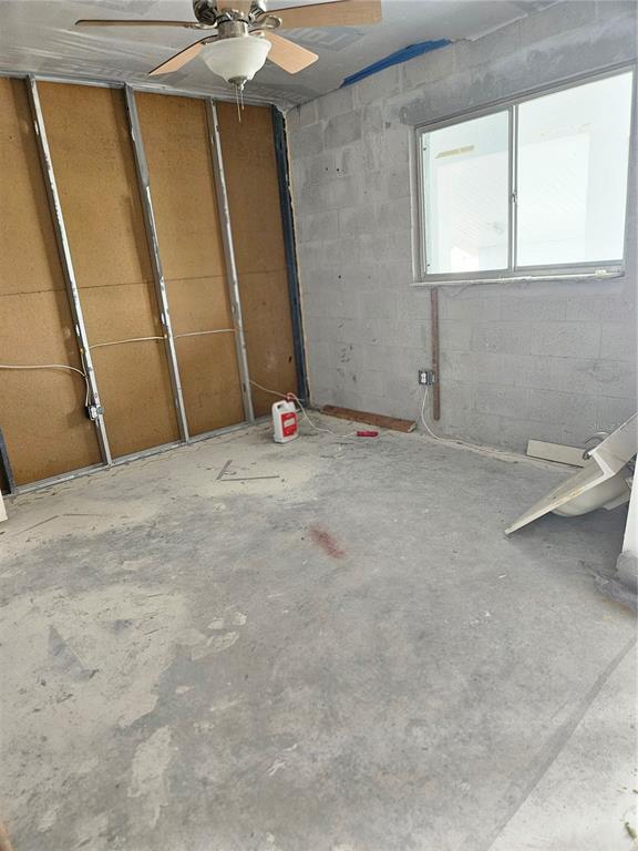 An unfinished room features exposed metal wall studs, concrete block walls, and a concrete floor — 6800 PLACIDA ROAD UNIT 290, ENGLEWOOD, FL