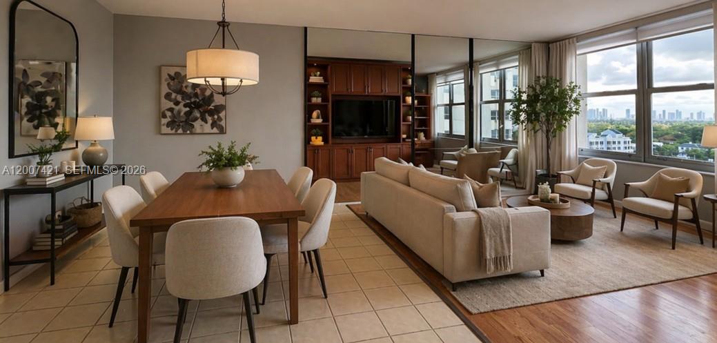A dining area and living room with tile and wood flooring, mirrors, and city views — 2899 Collins Ave # 1040, Miami Beach FL 33140, MIAMI BEACH, FL