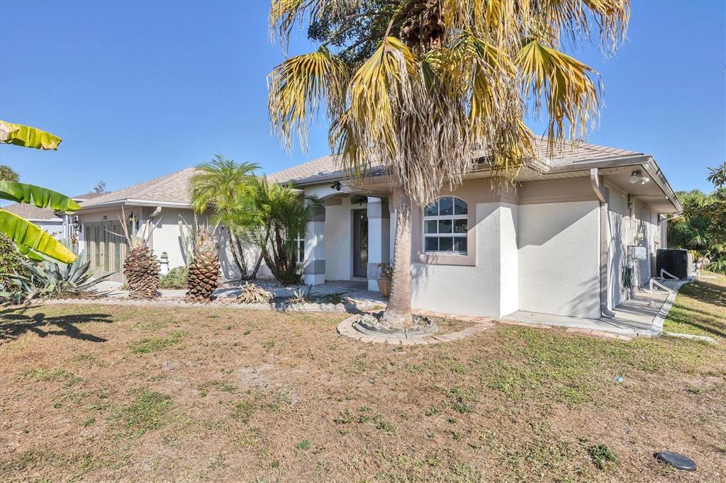 A single-story house with a palm tree in the front yard and a garage — 1236 NATRONA DRIVE, NORTH PORT, FL