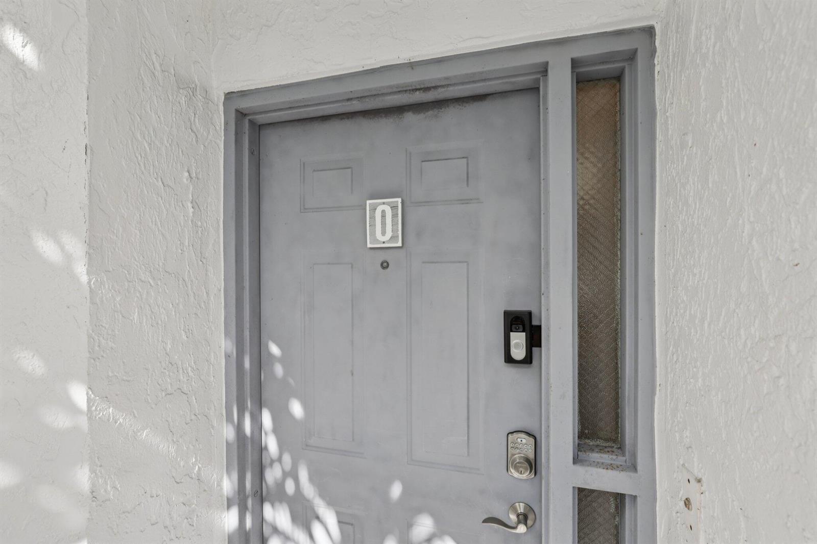 A gray front door with a number zero plaque and a smart lock — 5394 Firenze Drive # O, Boynton Beach FL 33437, BOYNTON BEACH, FL