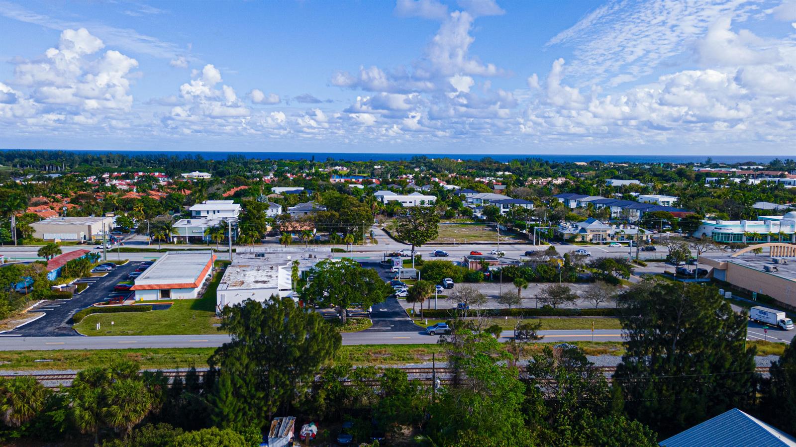 An aerial view shows a commercial area with parking lots, buildings, and surrounding residential neighborhoods — 1501 NE 3rd Avenue, Delray Beach FL 33444, DELRAY BEACH, FL