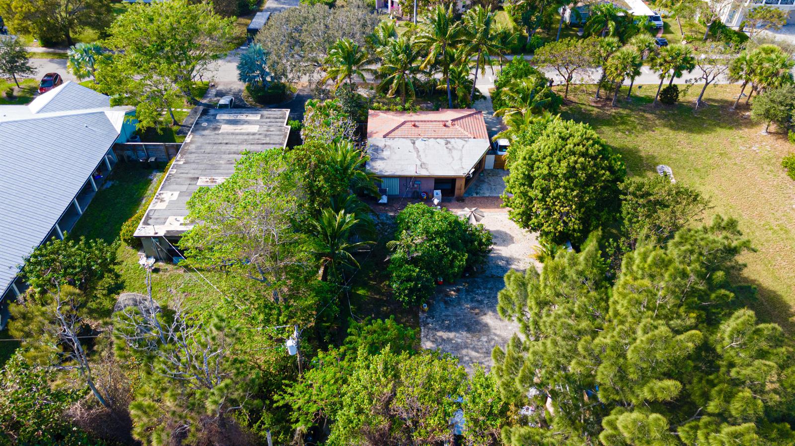 An aerial view shows a house with a tiled roof next to a flat-roofed building — 1501 NE 3rd Avenue, Delray Beach FL 33444, DELRAY BEACH, FL